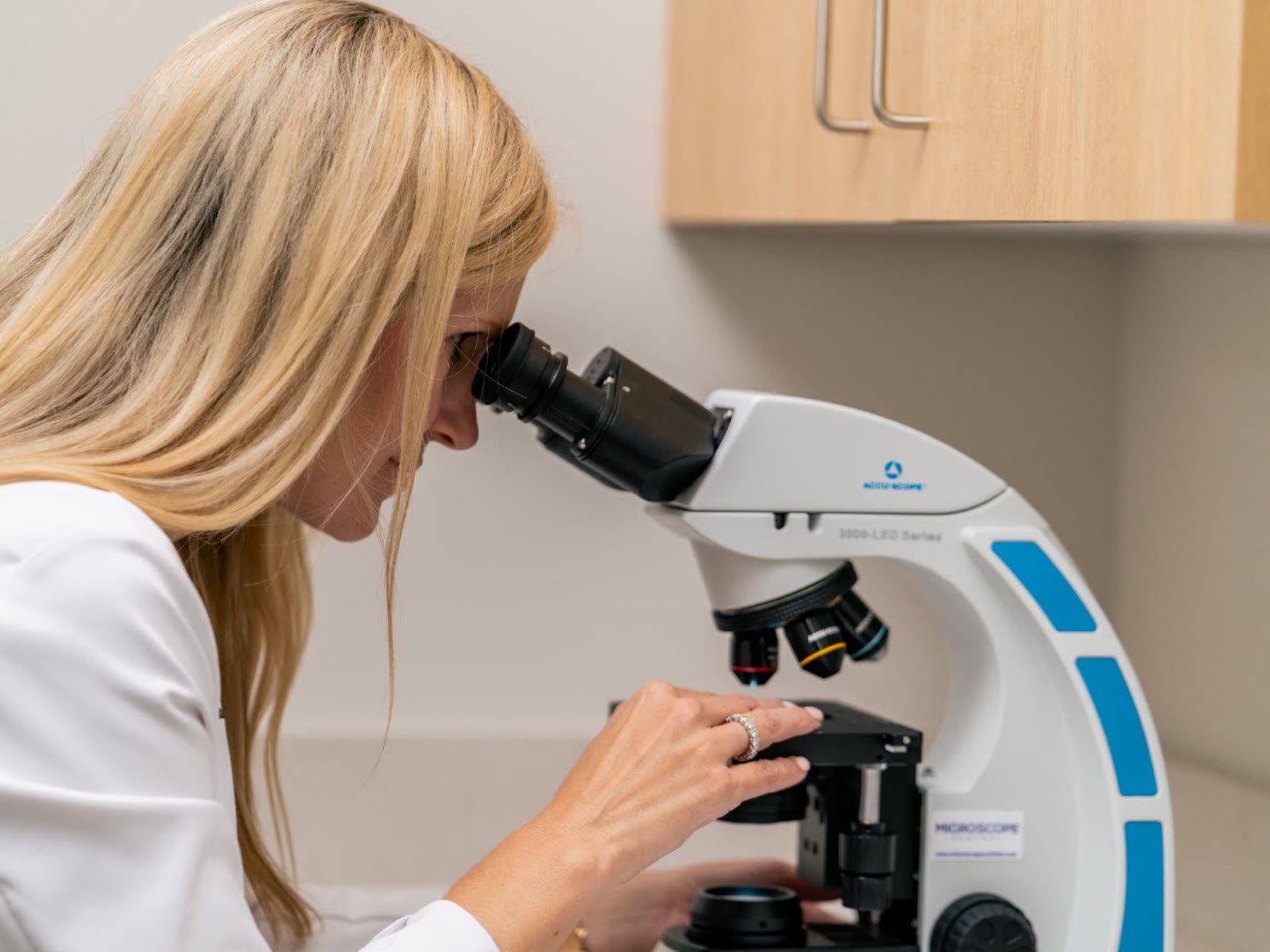 Dr. Sarah Wilson reading Mohs slides under the microscope at West Georgia Dermatology