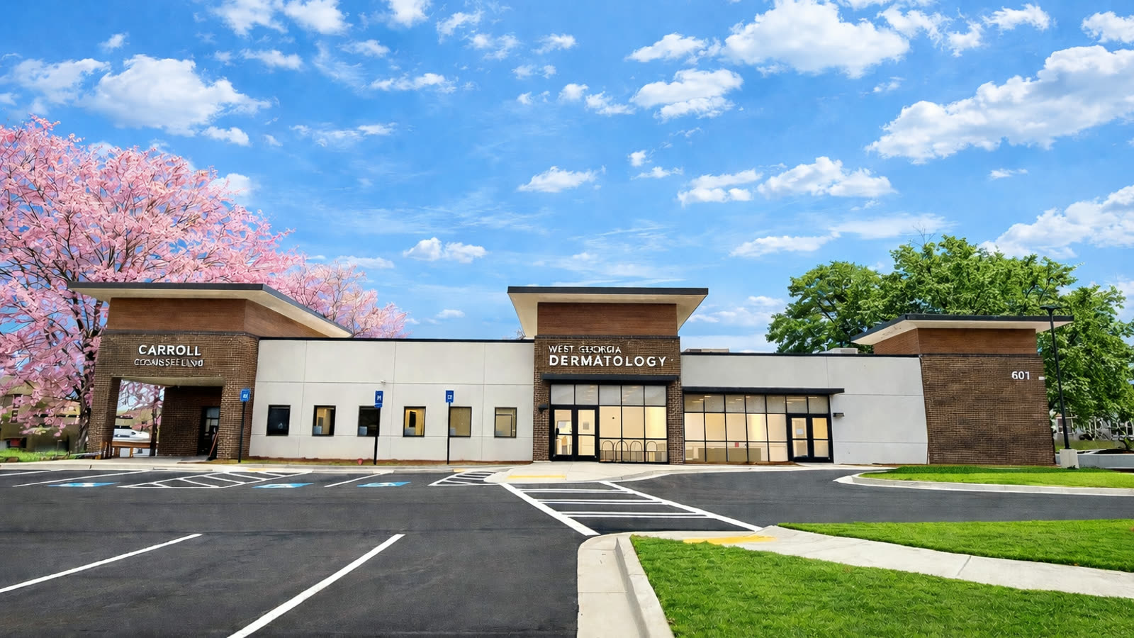 The West Georgia Dermatology office in Carrollton in spring, with blooming trees and the parking lot in front