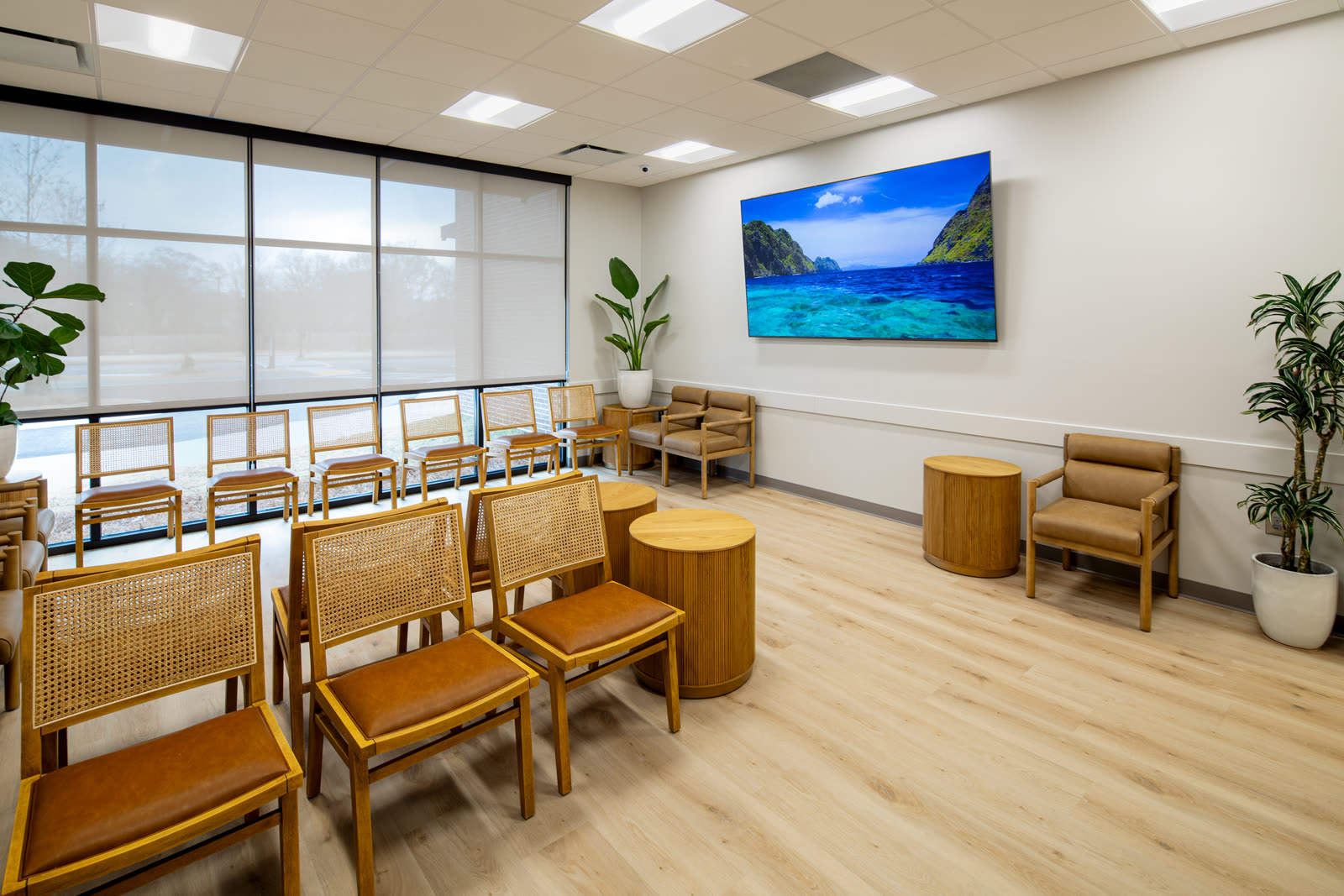 The waiting room at West Georgia Dermatology with cane-back chairs and natural light